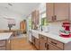 Stylish kitchen with quartz countertops, tile backsplash, stainless steel appliances, and view into a charming dining area at 27295 Tarbel Rd, Brooksville, FL 34602