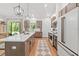 Modern kitchen featuring a large island with quartz countertop, stainless steel appliances, and ample cabinet space at 27295 Tarbel Rd, Brooksville, FL 34602