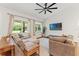 Bright and airy living room featuring a large sectional sofa and vaulted ceilings at 27295 Tarbel Rd, Brooksville, FL 34602