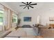 Comfortable living room with vaulted ceilings, large windows, and a ceiling fan at 27295 Tarbel Rd, Brooksville, FL 34602