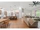Open-concept living room and kitchen area with hardwood floors and stylish furnishings at 27295 Tarbel Rd, Brooksville, FL 34602