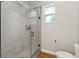Glass-enclosed shower with white subway tile surround, mosaic floor, and window at 27295 Tarbel Rd, Brooksville, FL 34602