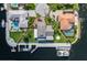 Waterfront home featuring a private boat dock, lush landscaping, and outdoor patio seating at 3150 Trident Ter, New Port Richey, FL 34652