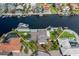 Aerial view showcases a waterfront property with a private dock and lush landscaping at 3150 Trident Ter, New Port Richey, FL 34652