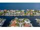 Aerial view of a waterfront community shows proximity to ocean with private docks, lawns, and homes at 3150 Trident Ter, New Port Richey, FL 34652