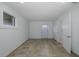 Finished basement space with neutral flooring, windows, and a doorway at 3150 Trident Ter, New Port Richey, FL 34652
