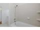 Bathroom features a white tiled shower and tub at 3150 Trident Ter, New Port Richey, FL 34652