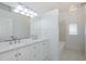 Bright bathroom featuring a double vanity, large mirror, and a shower/tub combo at 3150 Trident Ter, New Port Richey, FL 34652