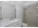 Bathroom featuring single vanity with quartz countertop, toilet, and walk-in shower at 3150 Trident Ter, New Port Richey, FL 34652