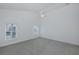 Large bedroom featuring carpet, ceiling fan, and water views at 3150 Trident Ter, New Port Richey, FL 34652