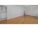 Bedroom with hardwood flooring, a doorway to a bathroom, and double closets at 3150 Trident Ter, New Port Richey, FL 34652