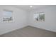 Bedroom with hardwood flooring, two windows offering natural light and a ceiling fan at 3150 Trident Ter, New Port Richey, FL 34652