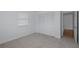 Bedroom featuring neutral carpet, window, closet and an open doorway at 3150 Trident Ter, New Port Richey, FL 34652