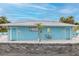 Exterior view of a Gulf Harbors Beach Club bathroom facility painted blue with a metal roof at 3150 Trident Ter, New Port Richey, FL 34652