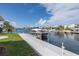 Wide angle of a dock where a sleek yacht is docked on a sunny day at 3150 Trident Ter, New Port Richey, FL 34652