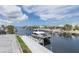 Dock featuring a large boat showcasing direct waterfront access and a luxury home in an idyllic neighborhood at 3150 Trident Ter, New Port Richey, FL 34652