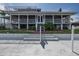 Beautiful exterior view of the waterfront home featuring a large deck, screened porch, and well-manicured lawn at 3150 Trident Ter, New Port Richey, FL 34652