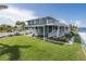 Waterfront home with expansive back patio, manicured lawn, and balcony at 3150 Trident Ter, New Port Richey, FL 34652