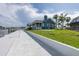 Exterior view of a waterfront home with a spacious lawn and a dock, blending coastal charm with modern living at 3150 Trident Ter, New Port Richey, FL 34652