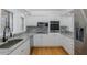 Bright kitchen with granite counters, stainless appliances, and white cabinetry at 3150 Trident Ter, New Port Richey, FL 34652