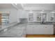 Modern kitchen with granite countertops, white cabinets, and views of the waterfront at 3150 Trident Ter, New Port Richey, FL 34652