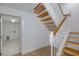 Bright staircase with wood treads and white risers, complemented by wood floors at 3150 Trident Ter, New Port Richey, FL 34652