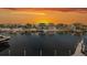Breathtaking sunset view over luxury waterfront homes with private docks and boat access on a calm waterway at 3150 Trident Ter, New Port Richey, FL 34652