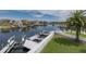 Waterfront view featuring a private dock with boat lift and surrounding luxury homes in a desirable neighborhood at 3150 Trident Ter, New Port Richey, FL 34652