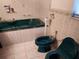 Bathroom with a green soaking tub, bidet, and a tiled surround at 3206 Pinon Dr, Holiday, FL 34691