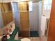 Bathroom featuring a tiled shower with glass doors at 3206 Pinon Dr, Holiday, FL 34691