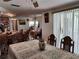 Bright dining area with views through to other dining space and the kitchen at 3206 Pinon Dr, Holiday, FL 34691