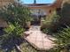 Inviting front entrance with tile walkway, mature landscaping and wrought iron gate at 3206 Pinon Dr, Holiday, FL 34691