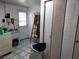 Laundry room with a utility sink, storage cabinets, and access to the exterior at 3206 Pinon Dr, Holiday, FL 34691