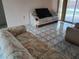Bright living room featuring tile floors, neutral walls, and comfortable seating arrangements at 3206 Pinon Dr, Holiday, FL 34691