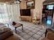 Cozy living room with tiled floors and access to the outdoor area at 3206 Pinon Dr, Holiday, FL 34691