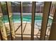 View of the screened-in pool area, featuring a tiled deck and clear, inviting water at 3206 Pinon Dr, Holiday, FL 34691