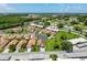 Aerial view showing the community featuring tidy lawns, complemented by a nearby lake and a highway in the distance at 3317 Abigail Ct, New Port Richey, FL 34655