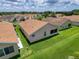 Aerial view showcases backyard of home with lush lawn and neighboring houses at 3317 Abigail Ct, New Port Richey, FL 34655