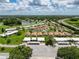 Expansive aerial view of a well-maintained community featuring lush greenery, a serene lake, and convenient highway access at 3317 Abigail Ct, New Port Richey, FL 34655