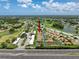 Scenic aerial view of a residential community featuring beautiful homes, lush greenery, and a serene lake at 3317 Abigail Ct, New Port Richey, FL 34655