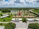 This aerial view showcases the home's location within a community, near a tranquil lake and an easily accessible highway at 3317 Abigail Ct, New Port Richey, FL 34655