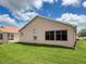 Rear exterior showcasing the manicured lawn, stucco exterior, and clean architecture at 3317 Abigail Ct, New Port Richey, FL 34655