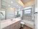 Bathroom featuring neutral tile, a white vanity, a large mirror, and a shower-tub combo at 3317 Abigail Ct, New Port Richey, FL 34655