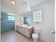 Bathroom with double sinks, and a large walk-in shower with glass doors at 3317 Abigail Ct, New Port Richey, FL 34655