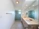Bathroom featuring double sinks, a large mirror, and a glass-enclosed shower at 3317 Abigail Ct, New Port Richey, FL 34655