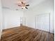 Bright bedroom with wood-look flooring, walk-in closet, and an attached bathroom at 3317 Abigail Ct, New Port Richey, FL 34655