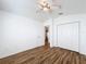 Bedroom with vaulted ceilings, ceiling fan, wood-look floors, and a closet for storage space at 3317 Abigail Ct, New Port Richey, FL 34655