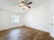 Bedroom featuring wood-look floors, a fan-light fixture, and bright window at 3317 Abigail Ct, New Port Richey, FL 34655