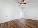 Bright bedroom with wood-look floors, arched window, and a closet at 3317 Abigail Ct, New Port Richey, FL 34655
