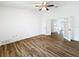 Bedroom with wood-look floors and a double French door entry to the adjacent room at 3317 Abigail Ct, New Port Richey, FL 34655